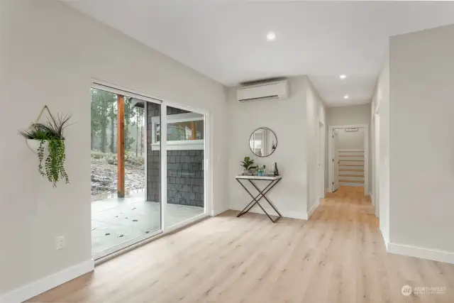 Oversize sliding doors on the main floor lead to an expansive covered rear patio, ideal for entertaining both indoors and out, a feature all PNW folks know and love.