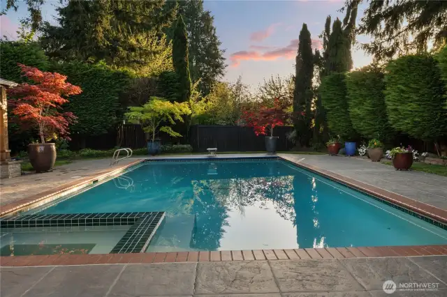 38 ft x 18 ft in-ground pool with integrated hot tub and electric cover for effortless safety and relaxation.