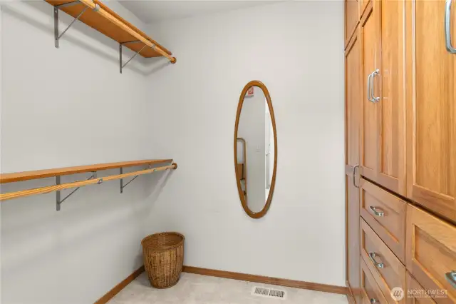 Custom walk-in closet with pecan cabinetry