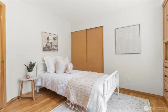 Second bedroom with beautiful custom built ins and a window seat view of the garden