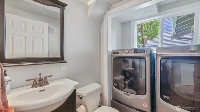 Convenient ½ bathroom connected to the laundry area, with washer and dryer included for your ease