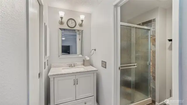 The en suite is a stylish ¾ bathroom featuring elegant finishes throughout the shower and surrounding areas!