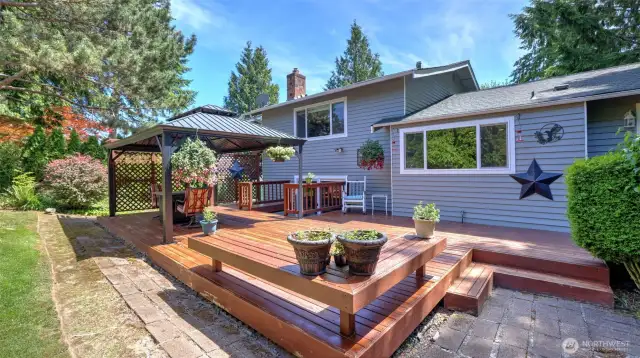 The charming gazebo stays, making this wooden porch perfect for year-round BBQs and relaxed patio hangouts