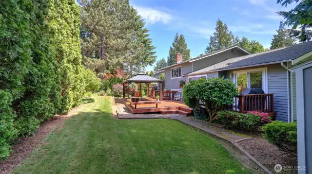 Beyond the porch, enjoy a spacious grassy yard—ideal for recreational activities and outdoor fun.