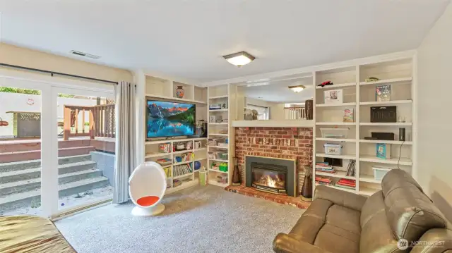 Walk down to the lower level where fresh trim and doors accentuate the space, and a custom slider fills it with natural light. A comfortable living area awaits for occasions and casual hangouts