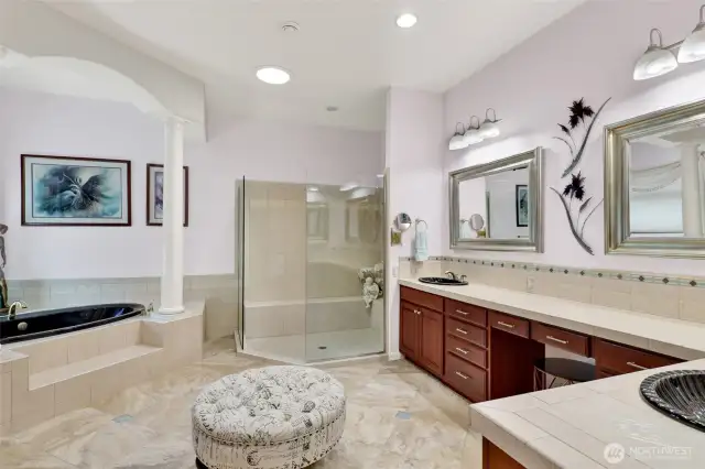 Spa-like primary bath features a soaker tub, double-sinks, lots of counterspace and huge shower