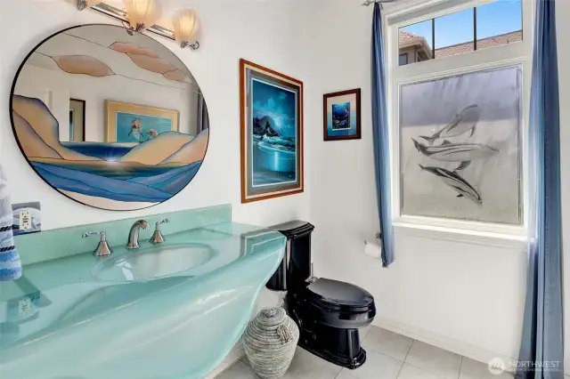 Half bathroom has a beach theme (mirror does not convey)