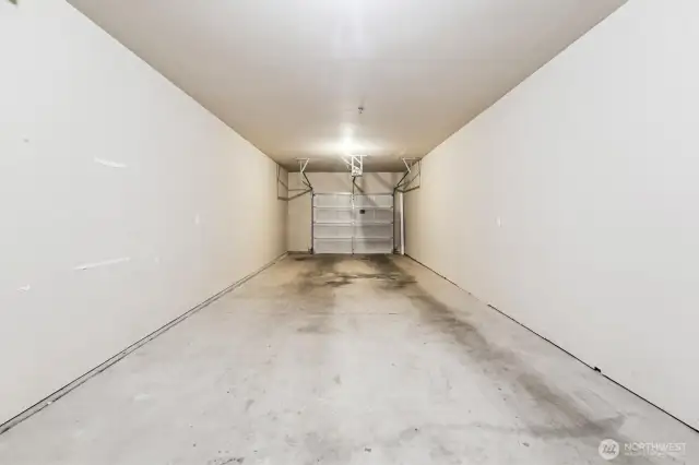 Attached tandem garage with extra space for storage.