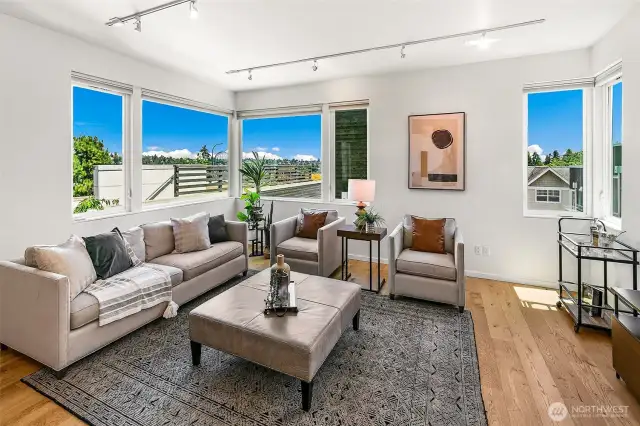 Living Room with a View  The heart of the home, this light-filled living room invites lingering with its panoramic outlooks and effortless flow. Framed by sky and treetops, it reflects Harold’s Place’s commitment to design that elevates everyday life.