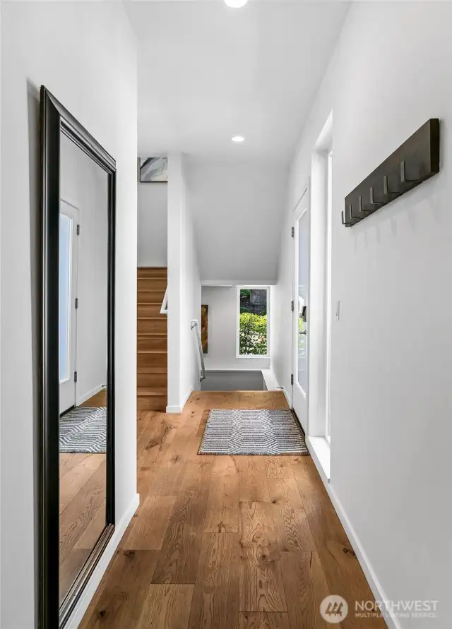 A light-filled ascent. Framed by soaring ceilings and generous windows, this stairway transition reveals the home’s vertical elegance—drawing the eye upward and flooding each level with natural light.
