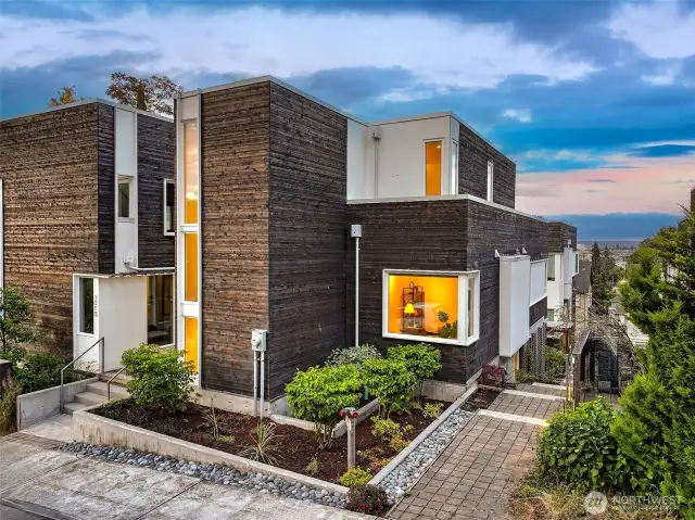Street presence with soul. At the edge of Harold’s Place, the home’s expressive form and warm window glow frame the street while revealing the corner office within—where creativity meets community in quiet dialogue.