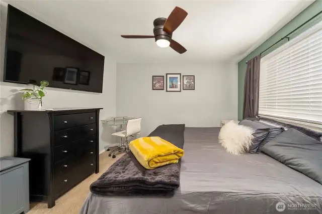 A generous layout provides flexibility for sleeping, working, or relaxing. The clean wall space offers multiple layout options, while the ceiling fan ensures year-round comfort. The room is wired and ready for wall-mounted media and offers a peaceful, light-filled environment.