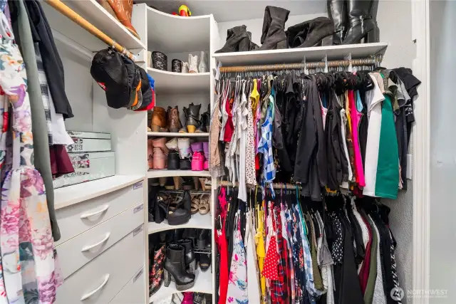 This spacious walk-in closet offers smart built-in organization with shelving, drawers, and dual hanging rods to maximize storage. With plenty of space to keep everything neatly arranged, it’s a practical extension of the primary suite that makes daily routines a breeze.