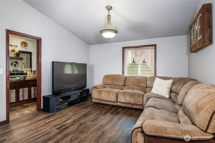 Luxury Vinyl Plank floors, vaulted ceilings and window placement for perfect theater set up - adds a whole additional space for gatherings or entertaining!