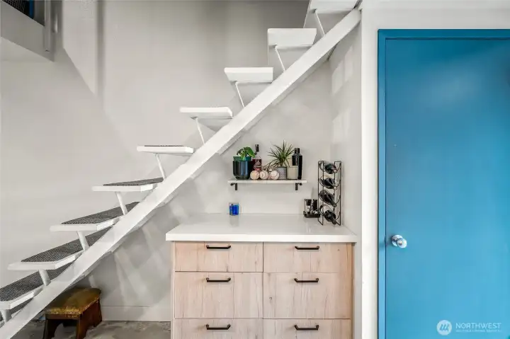 Custom-built bar nook tucked under the stairs — a rare entertaining feature.