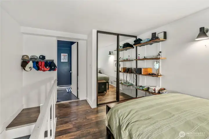 Loft bedroom with oversized closet + luxury plank flooring.
