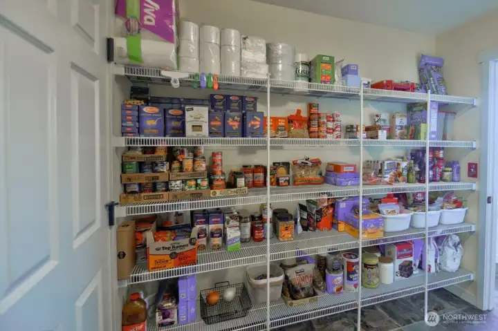 Pantry/mud room area with more than ample space for all those pantry needs. Leads to garage