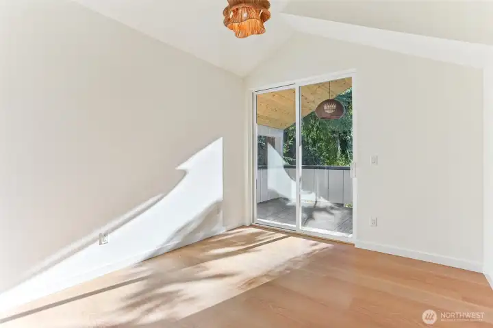 Primary with hardwoods and vaulted ceilings