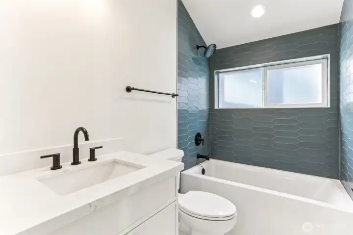 Full tiled bath with high ceilings