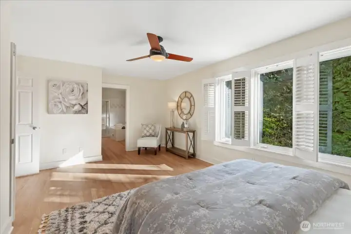 Oversized double doors open into the primary suite, which includes a pocket door between the bedroom and bathroom for enhanced privacy.