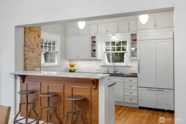 A kitchen eating bar offers options for more  casual seating, or chatting with the cook.