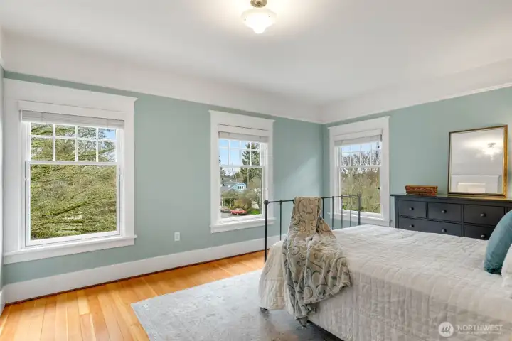 The primary bedroom is on the NW corner  with multiple windows for natural light. This  room faces the front of the house.