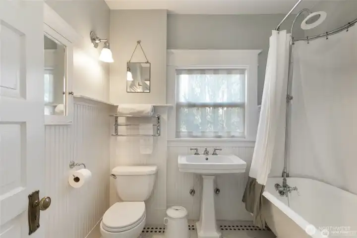 The upstairs hall bathroom was updated in  keeping with the original style.