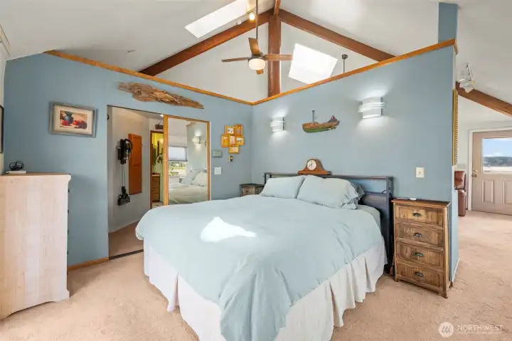 Primary bedroom with vaulted ceilings