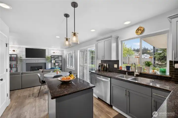 Kitchen features new refrigerator, dishwasher, and granite countertops.
