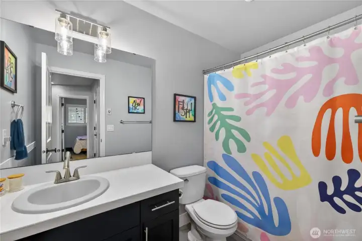 Upper hall bathroom has full-sized tub/shower combo.