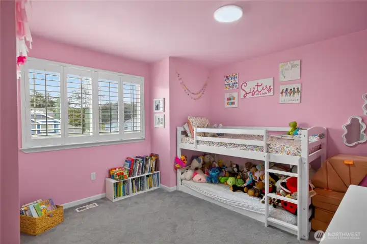Bedroom 3 has large windows bringing in natural light.