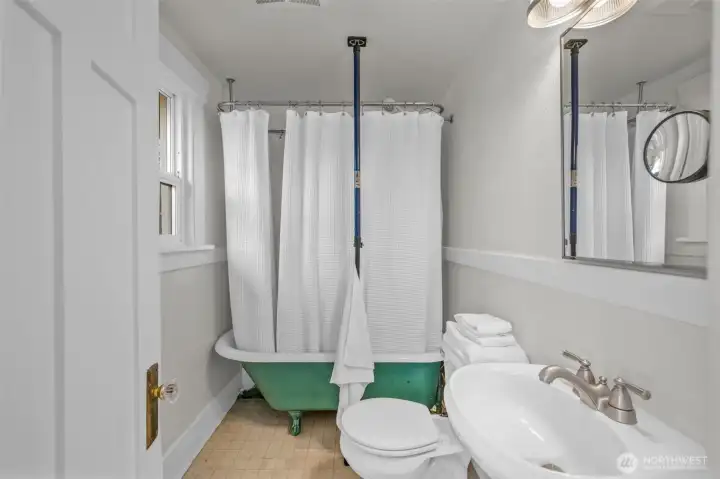 A vintage claw foot tub serves this bath. Updated sink and toilet.
