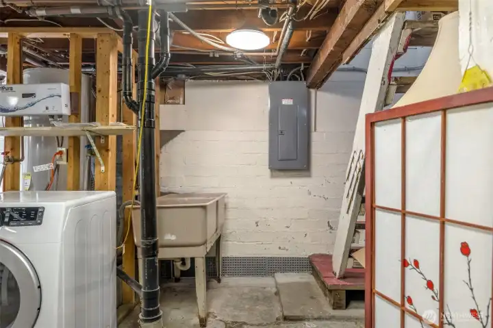 Updated electrical panel draws additional power from solar panels. Note the laundry tub.