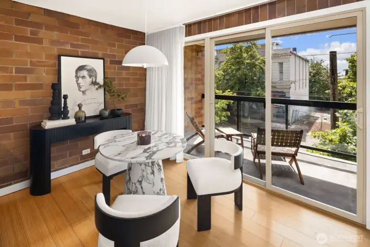 Enjoy meals bathed in soft northern light, with an easy transition outdoors regardless of weather since the large balcony is covered!