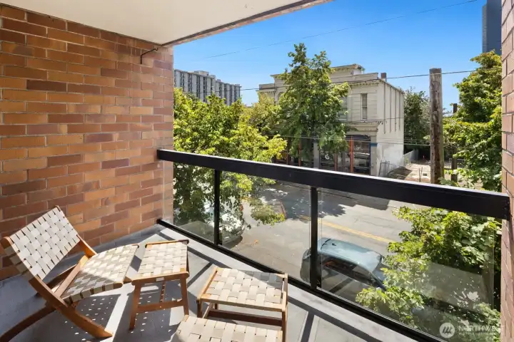 Your own covered outdoor retreat—ideal for morning coffee, evening wine, or simply watching the neighborhood go by, rain or shine.
