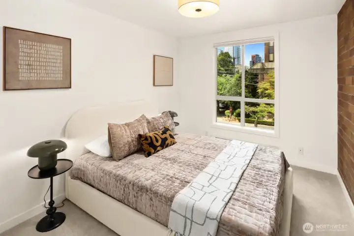 Whether it's a guest room, home office, or creative space, this flexible second bedroom offers brand-new carpet and calming neighborhood views.
