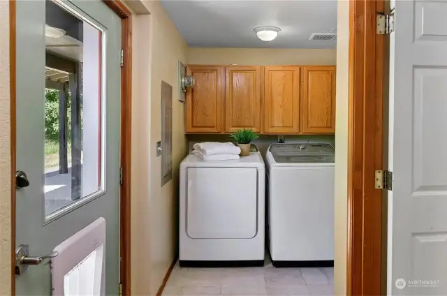 Easy access to the laundry room from outside, or the bathroom! And directly behind, are stairs up to the rest of the house -- let's go take a look!