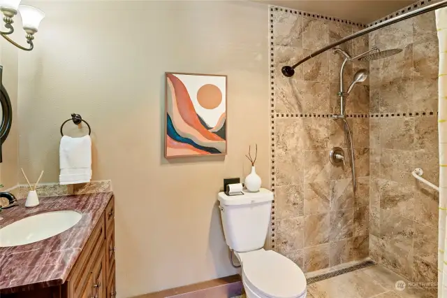 What a gorgeous surround and counters - the earth tones create a serene feeling in this bathroom.