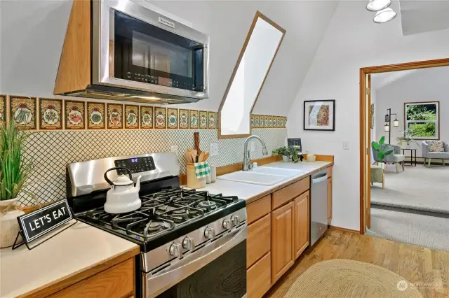 A perfectly sized galley-style kitchen, and yay - another gas stove! The window over the kitchen sink lets in tons of natural light.