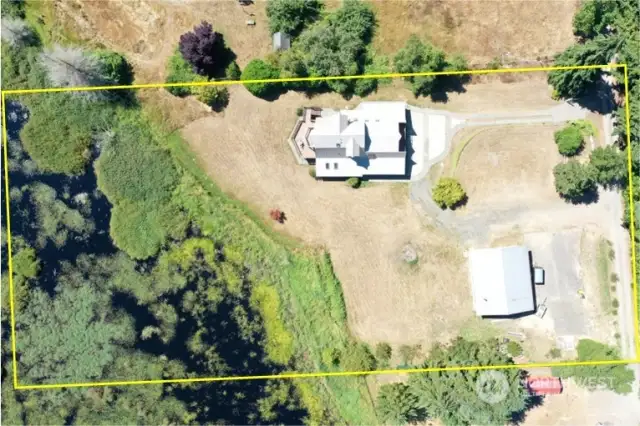 The aerial view here shows the approximate lot lines of the 2.39 acres.