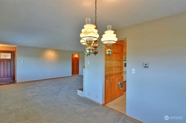 Formal dining room looking into the living room. Front door to the left.