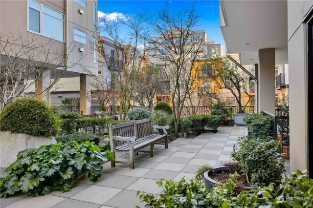 Between the two towers on the first floor is a large outside terrace with furniture groupings, water feature and beautiful plantings.