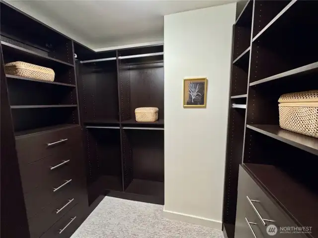 Enjoy custom California Closet systems the large walk-in closet in the primary suite.
