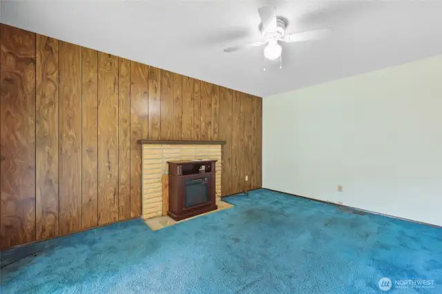 Family Room with fireplace & retro paneling- another groovy feature.