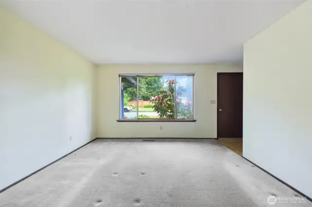Looking at the Livngroom window & space- hall is to the right- with the shared bath at the end.