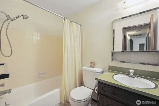 Shared bathroom with groovy yellow tile.