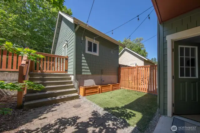 Private outdoor space with raised beds and room to garden, relax, or play.