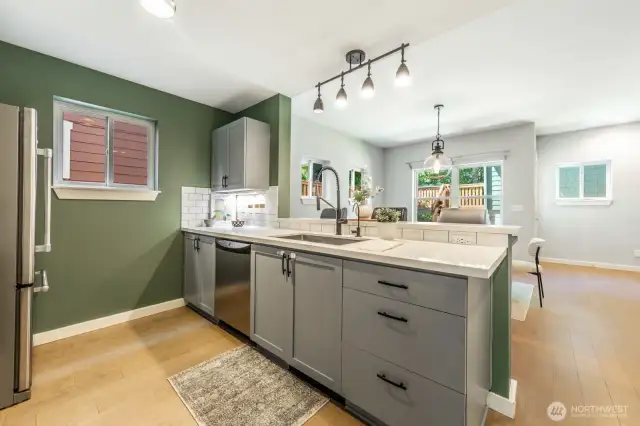 Modern kitchen with updated appliances and a seamless flow into the dining area and backyard.