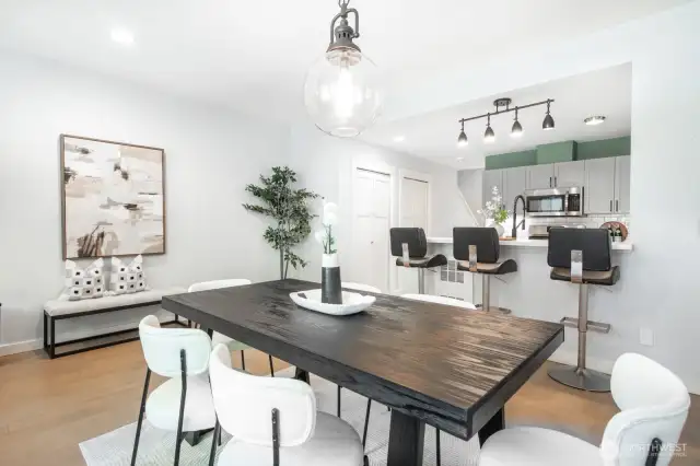Another view of the dining room showing its seamless flow into the kitchen, plus extra storage with two nearby pantries.