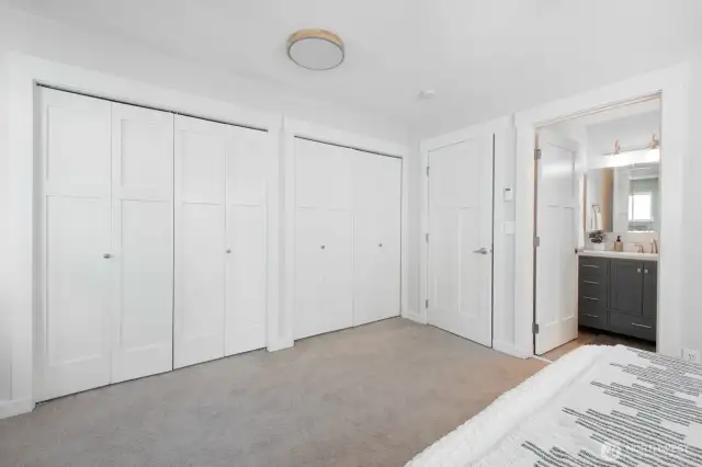 The primary bedroom features a full wall of closets, offering plenty of storage.